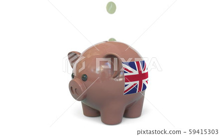 Putting money into piggy bank with flag of the United Kingdom. Tax system system or savings related 59415303