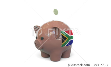 Putting money into piggy bank with flag of South Africa. Tax system system or savings related Putting money into piggy bank with flag of South Africa. Tax system system or savings related 59415307