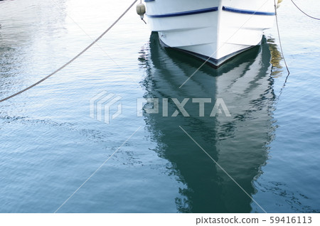 White color fishing boat moored in the harbor 59416113
