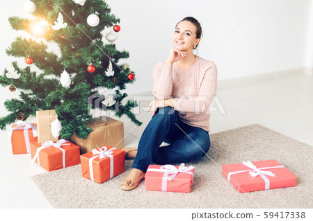 christmas, x-mas, winter, happiness concept - girl opens a gift against the background of the 59417338