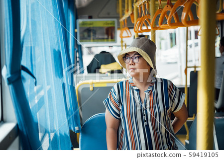 Asian woman travel by passenger bus in city 59419105