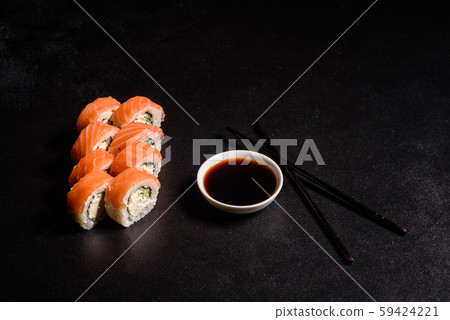 Various kinds of sushi served on a dark background Various kinds of sushi served on a dark background 59424221