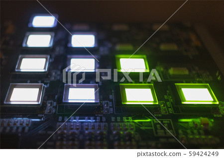 The process of checking several oled displays on the test station. Displays glow brightly of green and white color.Microelecronics.Display and light panel technology. The process of checking several oled displays on the test station. Displays glow brightly of green and white color.Microelecronics.Display and light panel technology. 59424249