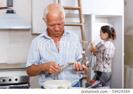 Man preparing faucet for installation Man preparing faucet for installation 59424384