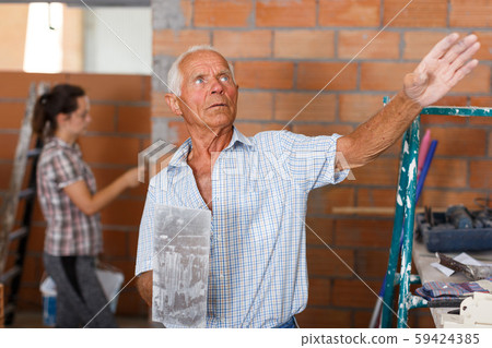 Elderly man controlling construction Elderly man controlling construction 59424385