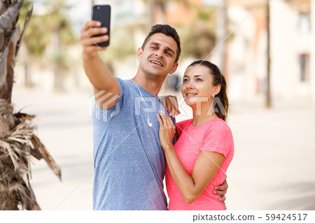 Sporty couple taking selfie Sporty couple taking selfie 59424517
