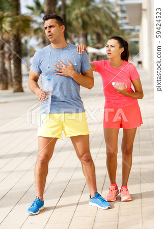 Tired couple resting after workout Tired couple resting after workout 59424523