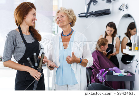 Smiling woman with stylist Smiling woman with stylist 59424633