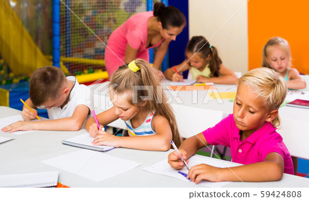 children sitting together and studying in class at school children sitting together and studying in class at school 59424808