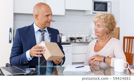 Agent showing box to woman Agent showing box to woman 59424881