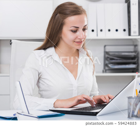 Young woman is working on laptop 59424883