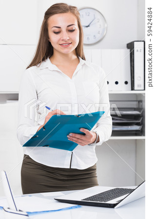 Young woman is signing profitable financial agreement 59424884