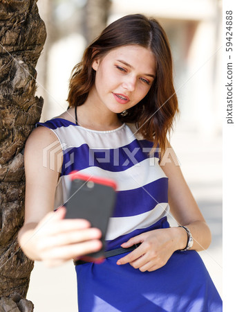 Girl posing and taking selfie Girl posing and taking selfie 59424888