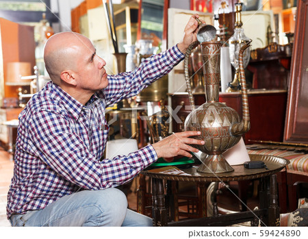 Man choosing ancient things in store Man choosing ancient things in store 59424890