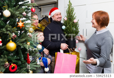 Man with family visiting mother for celebration of New Year 59425313