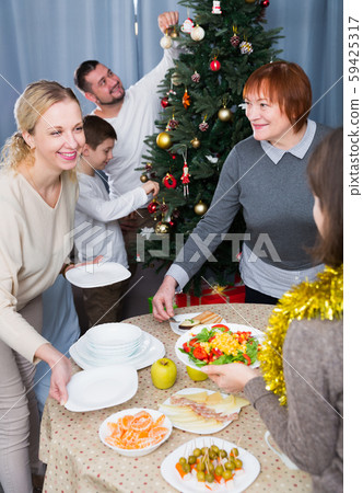 Family preparing for celebration of New Year Family preparing for celebration of New Year 59425317