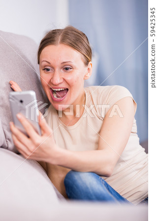 Laughing woman with phone 59425345