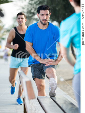 Smiling adult men are warming-up Smiling adult men are warming-up 59425611