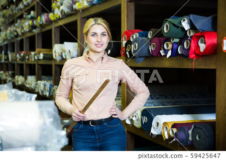 Salesgirl working in fabric store Salesgirl working in fabric store 59425647
