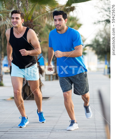 Two friends are jogging in time training Two friends are jogging in time training 59425676