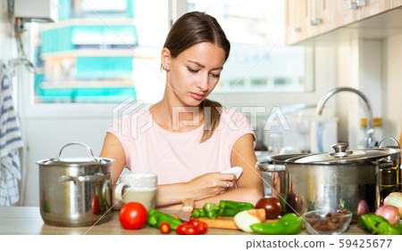Upset housewife trying to cook 59425677