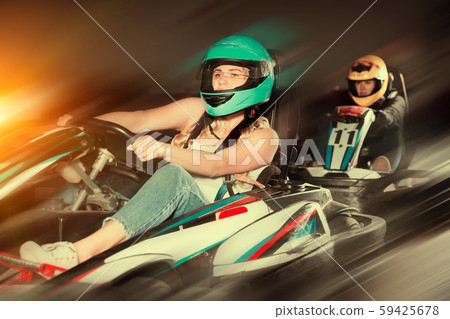 woman driving racing car at kart circuit woman driving racing car at kart circuit 59425678