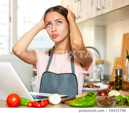 Sad and tired housewife sitting at kitchen Sad and tired housewife sitting at kitchen 59425796