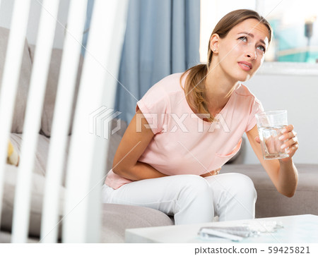 Unhappy female having stomachache Unhappy female having stomachache 59425821