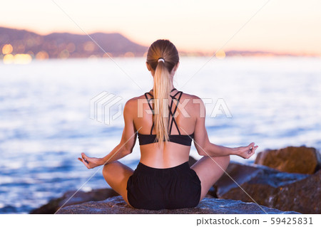 Female is meditating 59425831