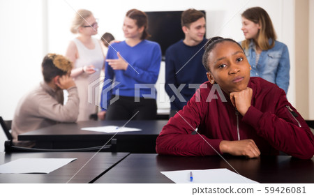 Girl student being shy among classmates Girl student being shy among classmates 59426081