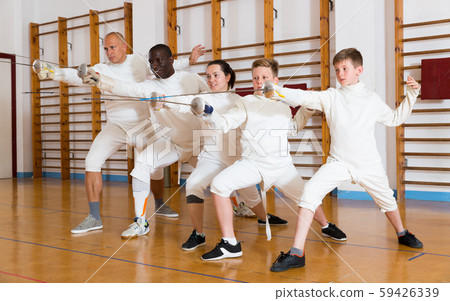 fencers posing with rapiers 59426339