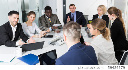 Multinational team of confident business partners discussing Multinational team of confident business partners discussing 59426379