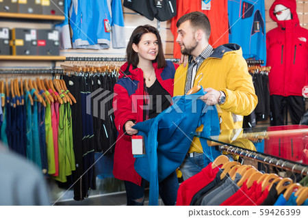 Couple deciding on track jacket Couple deciding on track jacket 59426399