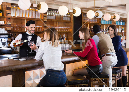 Portrait of barman and people who are standing near bar counter in luxurious restaurant 59426445