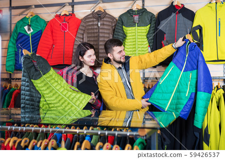 Couple examining windcheaters in store 59426537
