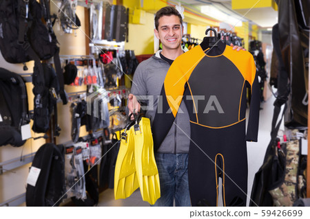 Smiling male standing with modern diving costumes and flippers 59426699