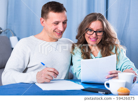 Couple signing papers Couple signing papers 59426875