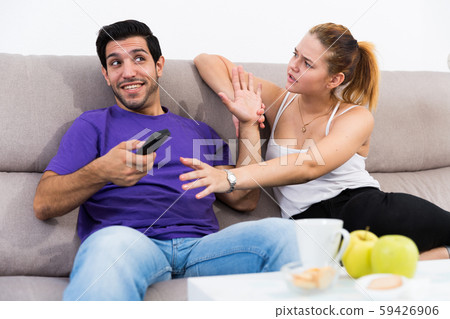 Couple arguing because of TV remote 59426906