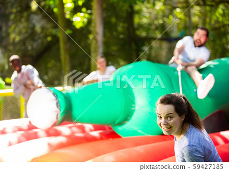 Funny attraction with a huge inflatable bottle in an amusement park Funny attraction with a huge inflatable bottle in an amusement park 59427185