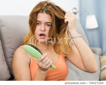 Portrait of female who is unhappy because her hair was deteriorated Portrait of female who is unhappy because her hair was deteriorated 59427204