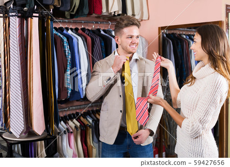 Couple choosing tie in store 59427656