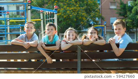 Glad children sitting on a bench Glad children sitting on a bench 59427660