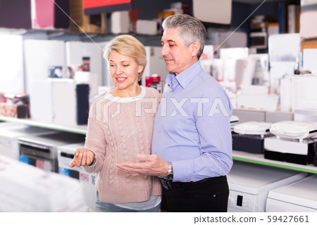 Husband and wife are visiting shop of household appliances for b Husband and wife are visiting shop of household appliances for b 59427661