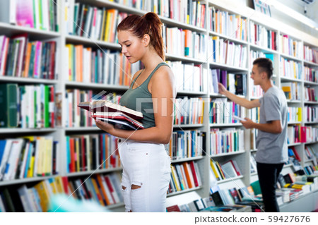 Girl holding open book in hands Girl holding open book in hands 59427676