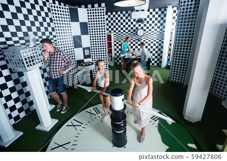 Family of five is having fun together in lost chessroom. 59427806