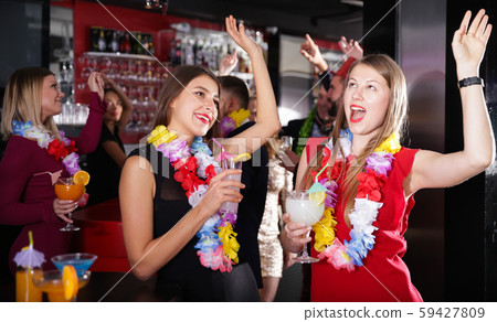 Two women on Hawaiian party at nightclub Two women on Hawaiian party at nightclub 59427809