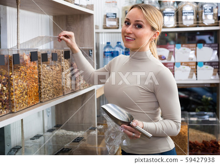 woman choosing nuts 59427938