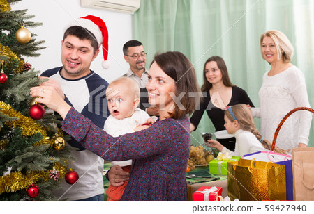 Happy family with Christmas tree at home. Happy family with Christmas tree at home. 59427940