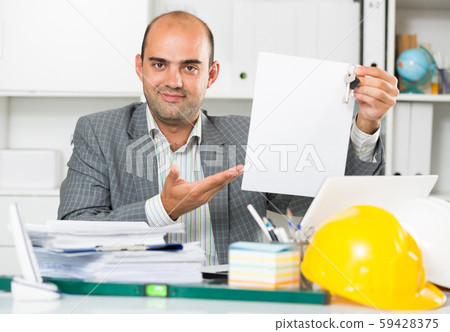Architect in office keeping keys in the hand Architect in office keeping keys in the hand 59428375