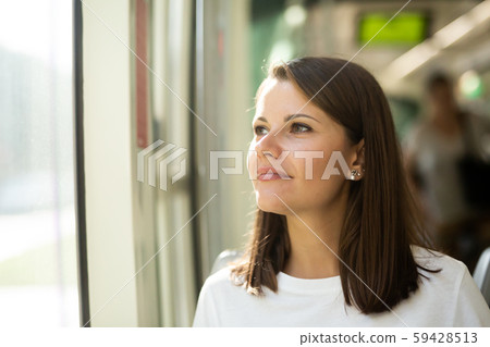 Woman traveling in modern streetcar Woman traveling in modern streetcar 59428513